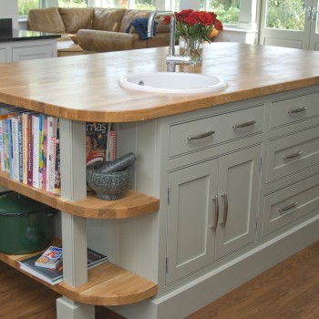 large kitchen island with oak worktop and prep sink