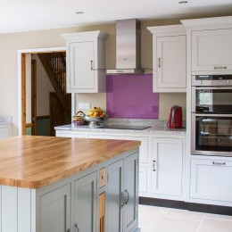 shaker kitchen with coloured glass splashback